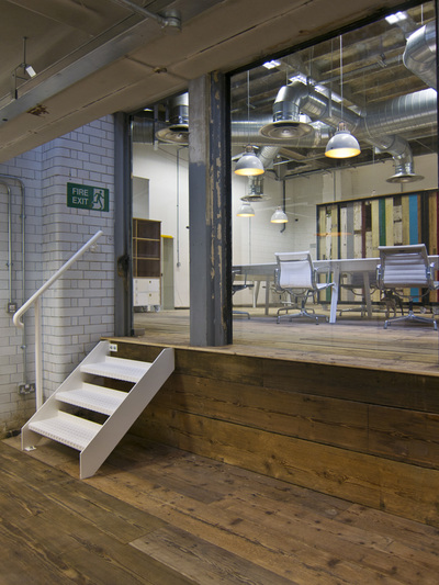 Office pod with bespoke mini white staircase, flooring reclaimed from a church and original white brick tiles