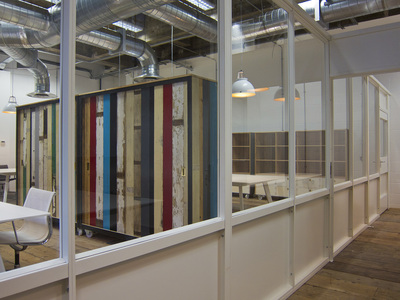 White and glass office partitioning in industrial space