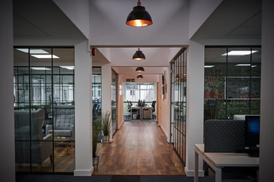 Open plan, recruitment office with critical style glass partition walls and large black pendant lights from Industville