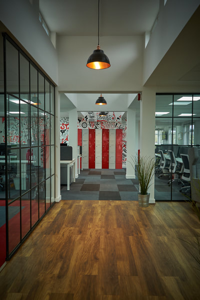 Open plan, recruitment office with critical style glass partition walls and large black pendant lights from Industville