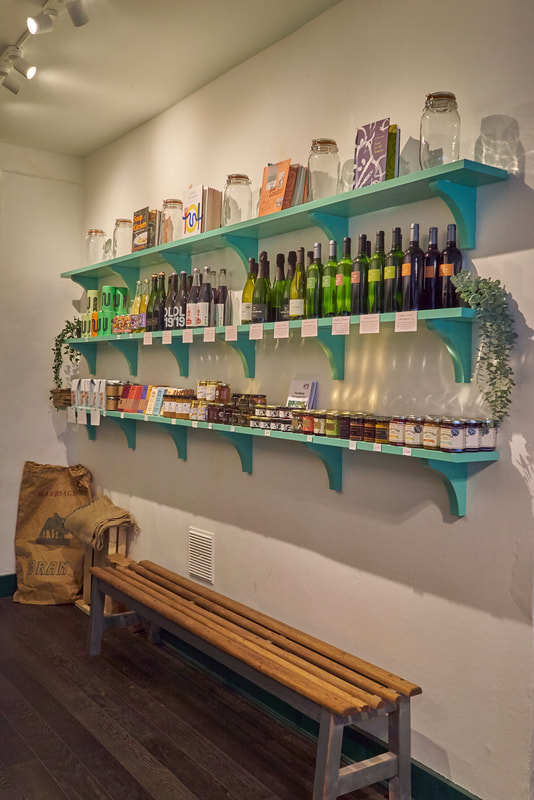 Mint Green shelves and vintage bench in Crouch End food store. Commercial, shop interior design. 