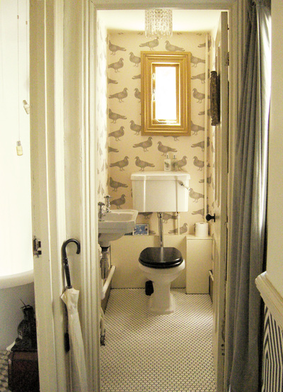 Lavatory with Savoy loo and sink, gold painted window frame, white, Penny mosaic floor and Thornback and Peel 'Pigeon' Wallpaper