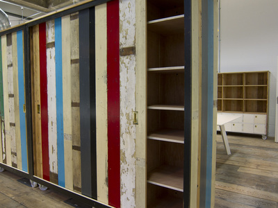 Tall cupboards made from reclaimed wood, with castors which double as room dividers