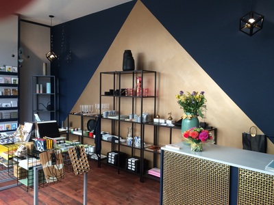 Boutique shop design with navy and gold painted walls