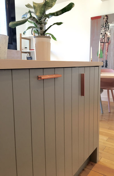 Grey Tongue and Groove kitchen With Pale Oak worktop and copper drawer pulls